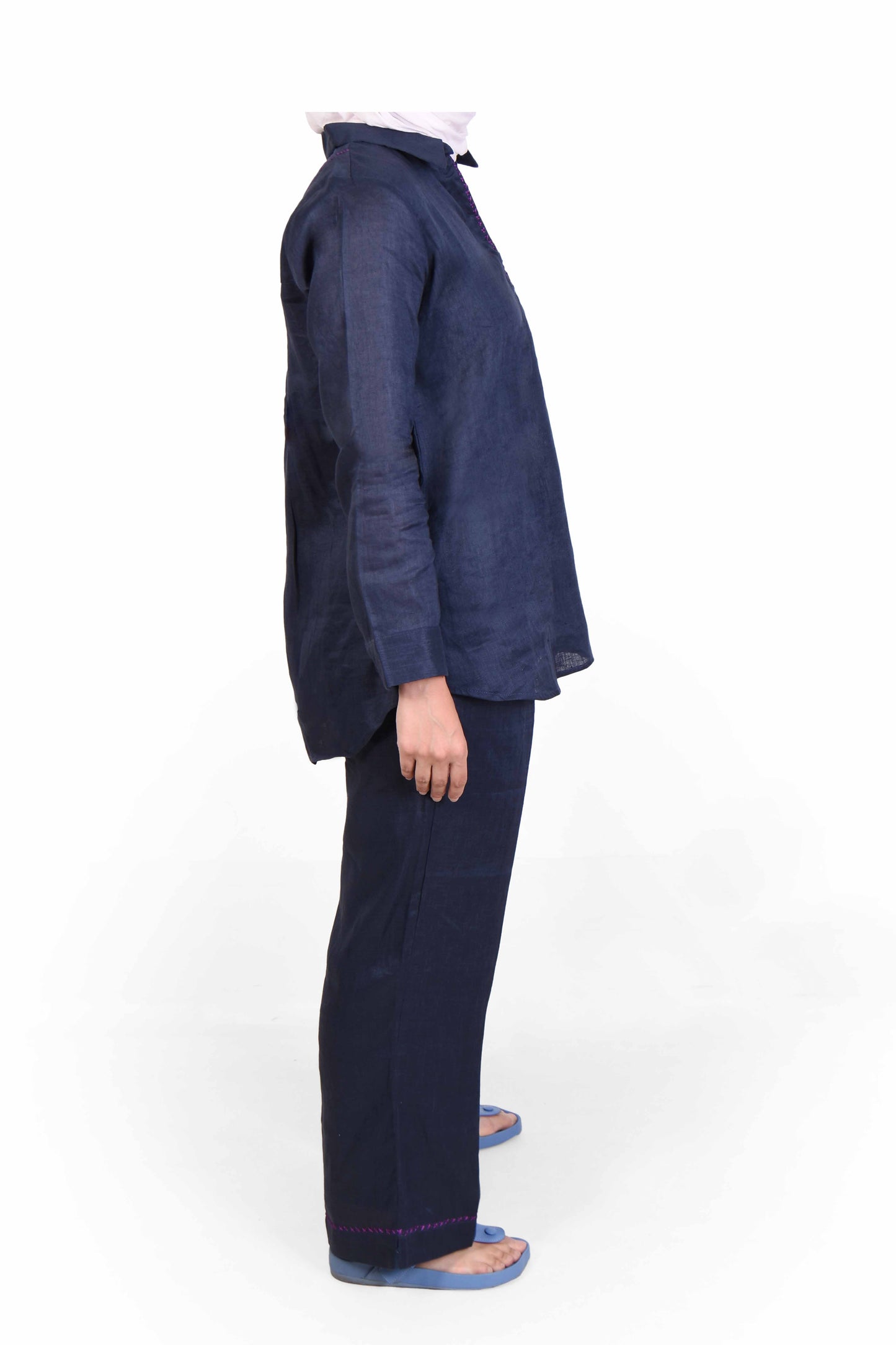 Woman in dark blue two-piece outfit lightweight summer wear on white backdrop