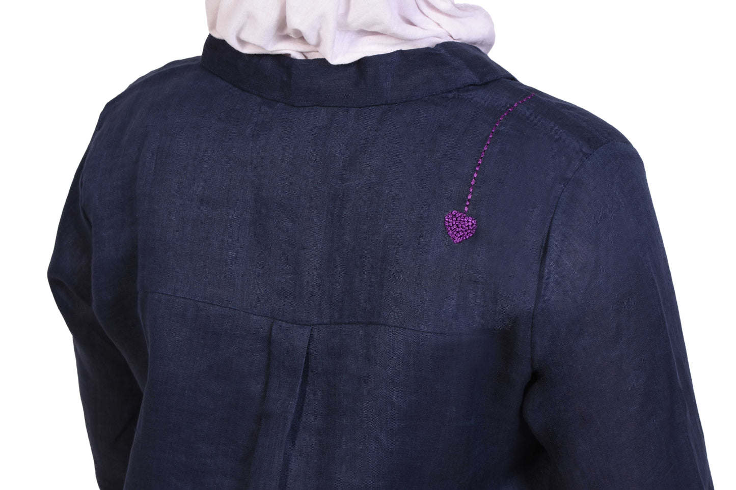 Detailed view of navy blue outfit with purple heart embroidery, sustainable fashion on white background