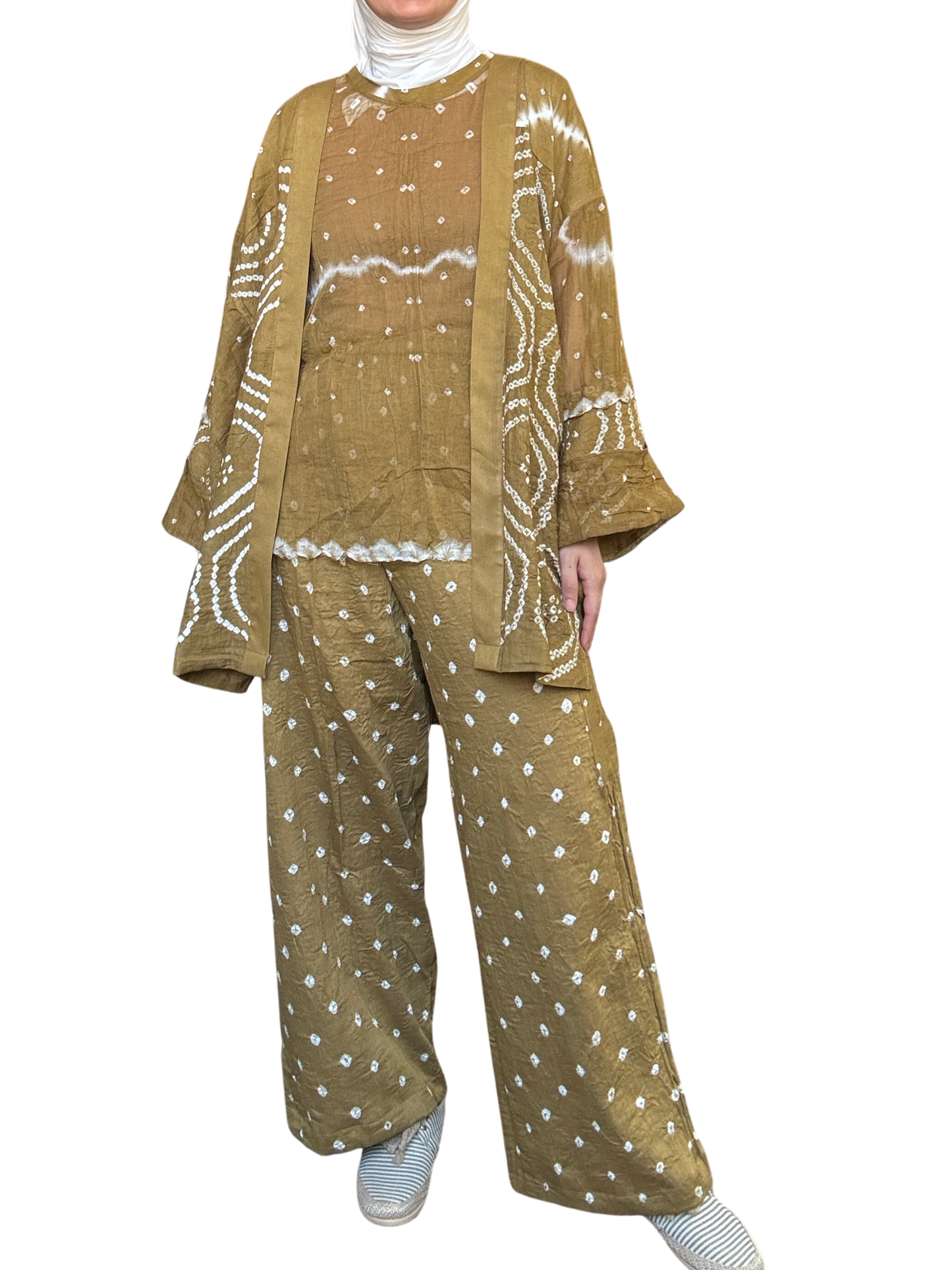 Woman wearing a patterned outfit with a jacket, top, and pants on a white background