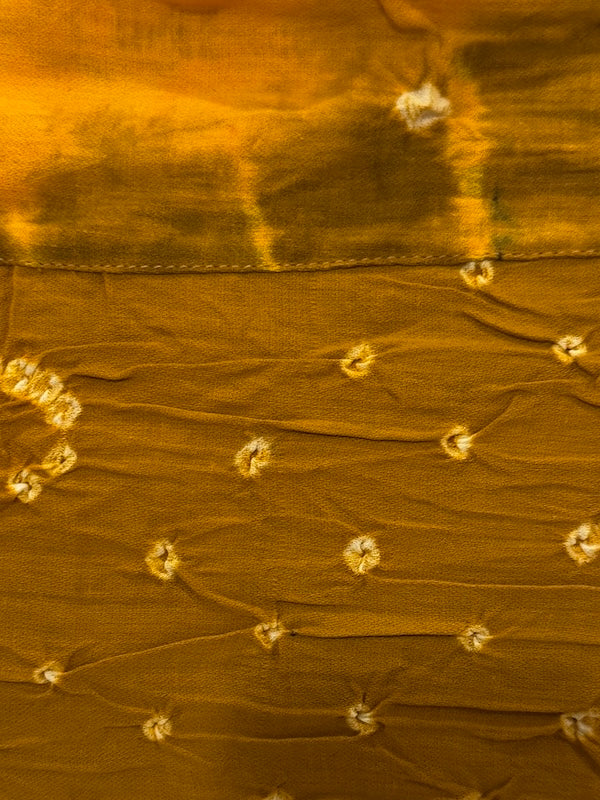 Close-up of brown fabric with floral embroidery
