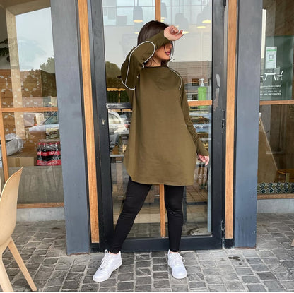 Woman wearing a Green Khaki active top with white thread detailing, suitable for sports or workouts