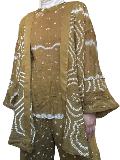 Brown outfit with white patterns on a plain background